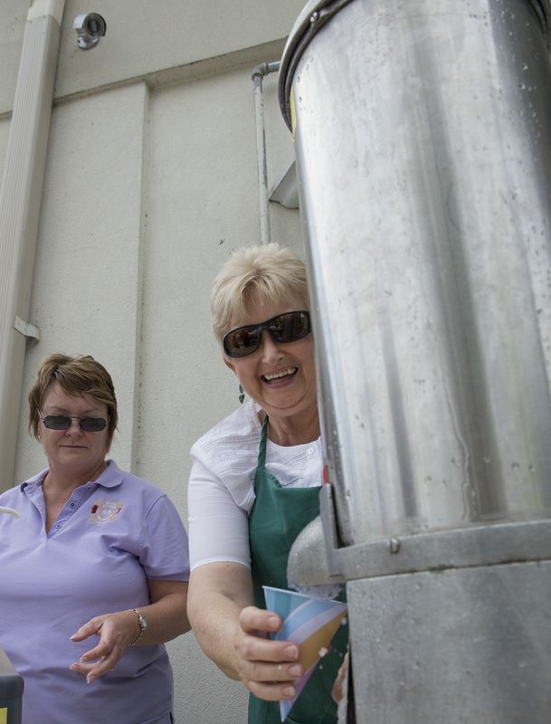 Milton Fire Department Ladies Auxiliary members Fran Kiser, left, and Susanne Messick serve snow cones at a blistering pace. BY DENY HOWETH