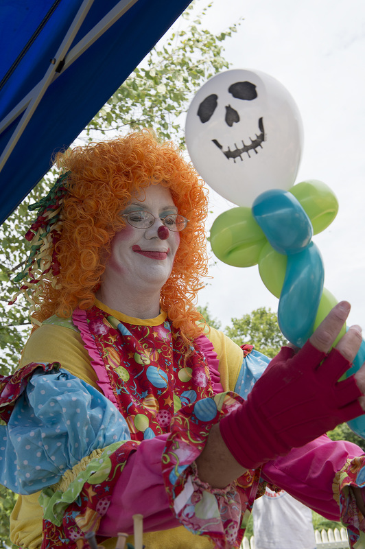 Snippy Doodles the clown creates balloon sculptures for the kids at Milton's Family Fun Day on August 10. BY DENY HOWETH