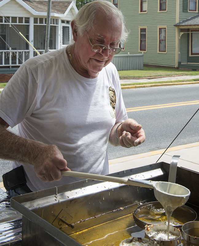 Marshall Reynolds from the Milton Lions Club poured funnel cakes for the hungry visitors. BY DENY HOWETH