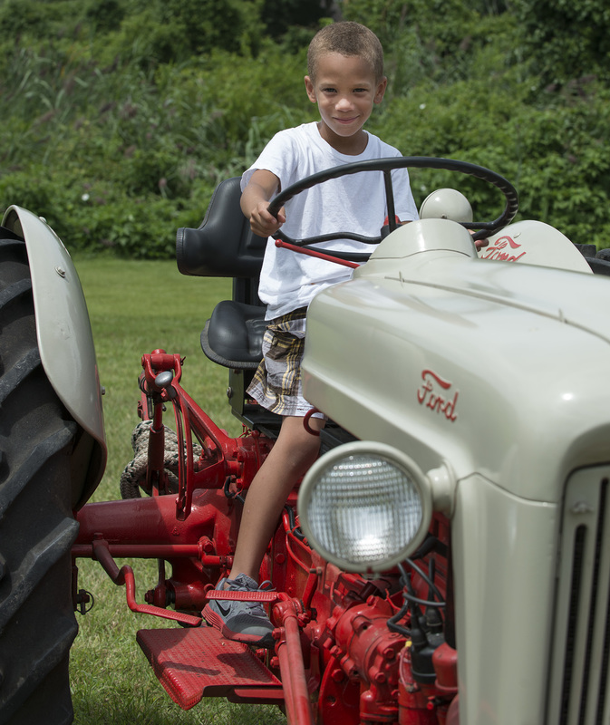 Tias Small, 7, sits atop the 1953 Ford Golden Jubilee Tractor once owned by Alvin and Gertrude Tharp of Lewes, now owned by Skip Betts. BY DENY HOWETH
