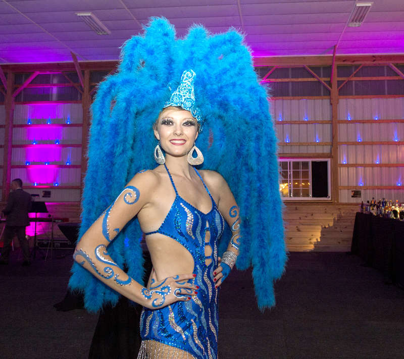 Proceeds from the Beaux Arts Ball will benefit the Rehoboth Art League Educational Outreach program. Shelby Scott is shown in a blue Vegas style showgirl head dress. BY DENY HOWETH