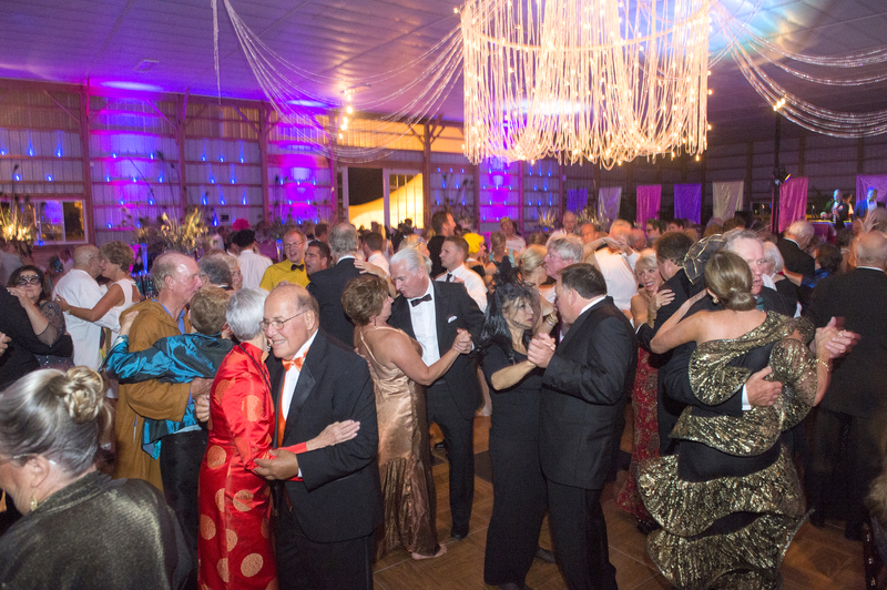 Attendees dance at the Beaux Ball in the transformed horse barn complete with an imported chandelier. BY DENY HOWETH