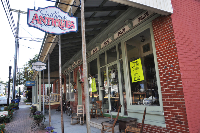 Signs on the windows of Jailhouse Antiques on Federal Street in Milton inform customers the business is leaving. The building was recently sold and the new owner is planning a renovation project. BY NICK ROTH