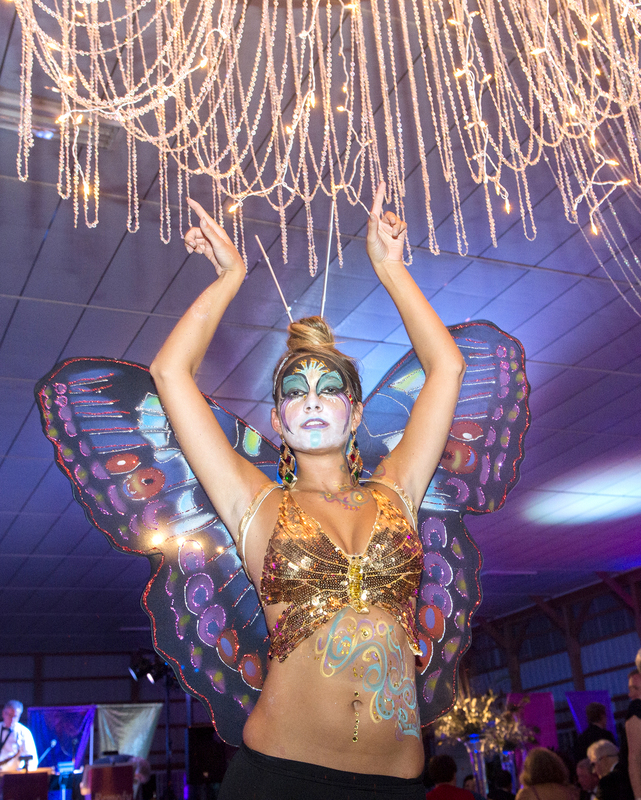 Exotic models greeted ball goers as they paraded past the horse stables to the arena transformed into the dining room. Underwriters for the event were Mary Ann and Mark Ronald, who graciously opened Belle Mead Farm for the evening. Hailley Baker, a student at Indian River High School, helped create the costumes for the models. Her face painting was created by artist Sherry Biele. BY DENY HOWETH