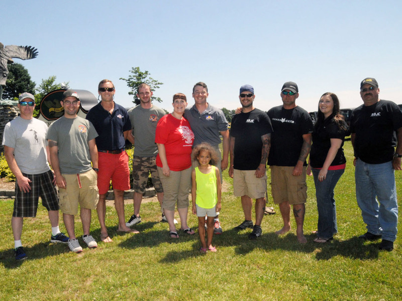 The Southern Delaware Jeep Club helped out with the benefit. Shown are club members and the event organizer (l-r) Kris Thorton, Tyler Hilcan, Casey Kenton, Caleb Stevens, Rachel Baron, event organizer and Heroes in Need Founder Kevin Baron, Chris Bosley, Mike Perry, Heather Devich and Tim Morris. In front is Bianca Thorton. BY STEVEN BILLUPS