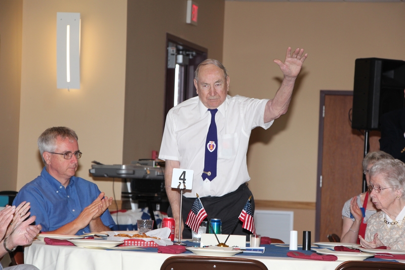 John Sauer, Military Order of the Purple Heart and World War ll D-Day invasion participant, rises to a round of applause. The Fr. Capodanno Assembly No. 2413 Knights of Columbus hosted a dinner dance to celebrate Wounded Warriors and the members of the Association of the Military Order of the Purple Heart. SOURCE SUBMITTED