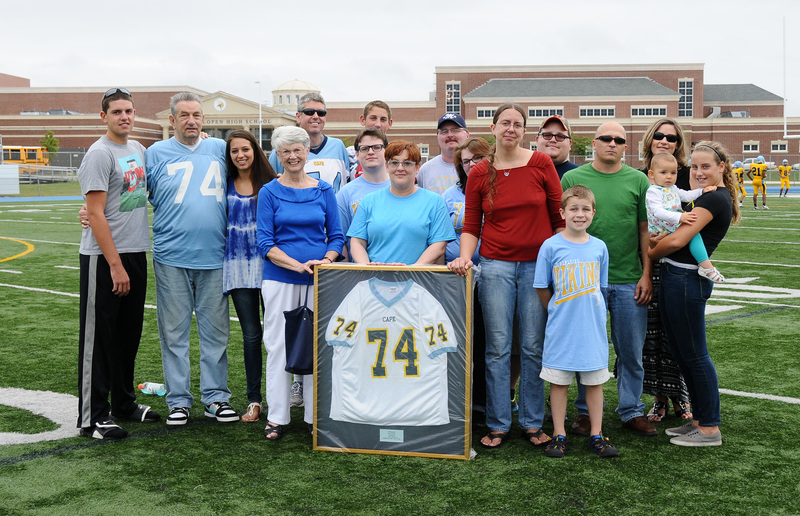 The late Jeff Burnham, Cape class of 1986, was honored at halftime in the Vikings vs. Cape May game as his family was presented with his No. 74 jersey. In front center, Jeff's mother, Faye; wife, Tammy; and sister, Cindy hold the framed jersey. Jeff, a Vikings football and baseball standout, passed away June 21 from colon cancer. BY DAN COOK