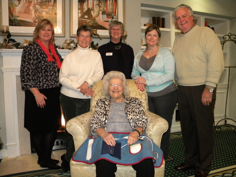 Shown at the presentation in back are (l-r) Kathy Jacobs, marketing and community liaison at Brandywine; Lauri Pavlik; Jamie Magee, Sussex County coordinator for the Alzheimer’s Association; Eileen Bennett, administrator at Brandywine; and John Wood. Rita Kilby, a resident at Brandywine, is seated and helps display one of the aprons. SOURCE SUBMITTED