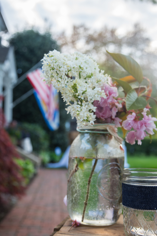 Fresh cut flowers in clear jars on wooden crates set the spring theme for the dinners. BY DENY HOWETH