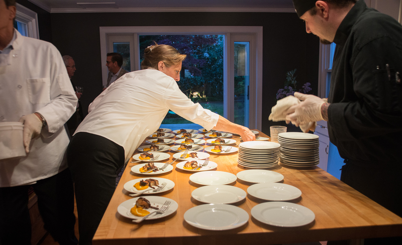 Lisa McDonald and Aaron Berg prep braised pork belly, sweet carrot puree and smoked cherry BBQ sauce. BY DENY HOWETH