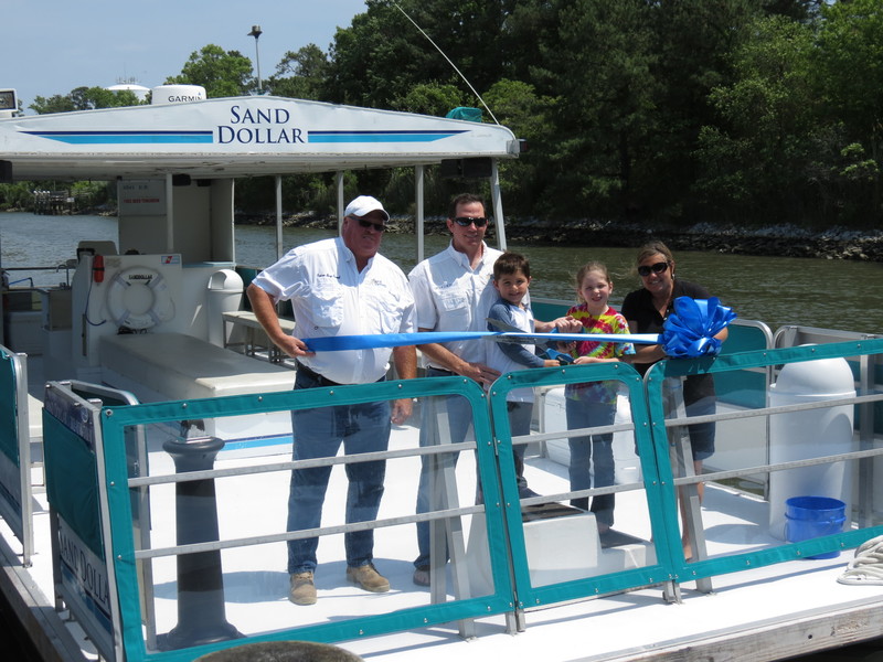A ribbon cutting was held to celebrate the private cruise boat The Sand Dollar joining the Rehoboth Beach-Dewey Beach Chamber of Commerce. Shown are (l-r) Capt. Harry Caswell, Capt. Don Tollett, Ben Tollett, Lucy Tollett and Patty Burkentine of the Rehoboth Beach-Dewey Beach Chamber of Commerce. SOURCE SUBMITTED