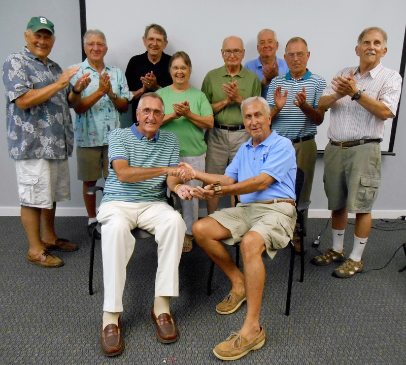 Former Inland Bays Foundation President Ron Wuslich, front left, hands the gavel to new President Doug Parham, front right, with applause from board members (l-r) Tony Caputo, Allen Allenspach, George S. Cole, Frances Hart, Dave Jaeger, Carl Mantegna, George Bunting and Chuck Schonder. BY MADDY LAURIA