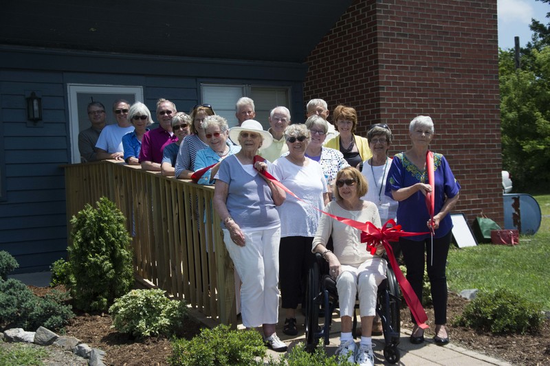 Board members and elected officials gather on the new wheelchair ramp outside of the Greater Lewes Community Village June 30.