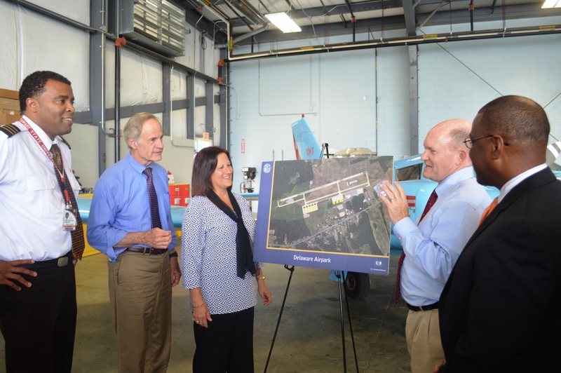 U.S. Senator Chris Coons (second on right) and U.S. Senator Tom Carper (second on left) discuss the benefits of new Delaware Airpark runway and taxiway system project with Lori Pagnanelli, Manager, Harrisburg Airports District Office, FAA Eastern Region, current UPS pilot and DSU alum Dave Harding (far left) and DRBA Airports Director Stephen Williams (far right). The project is expected to be completed in 2017. BY DRBA