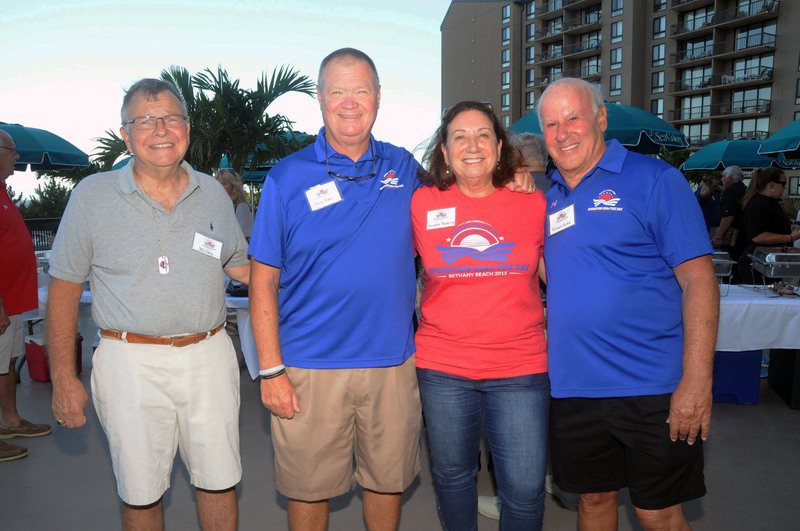 Organizers volunteers and board members of the Operation SEAs The Day gather at the Sea Colony Resort beachfront patio just prior to the cookout. Shown are (l-r) Bill Gray, volunteer; Chris Ross, Operation SEAS The Day vice president; Annette Reeping, board member; and Richard Katon, board member and founder. BY STEVEN BILLUPS