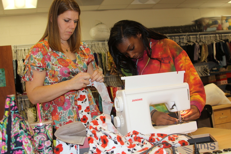 Textile teacher Alayna Aiken helps junior Makayla Bowen with her project. BY MELISSA STEELE