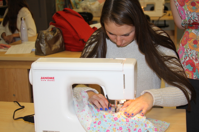 Junior Samantha Frederick sews a pocket on the shirt she is making. BY MELISSA STEELE