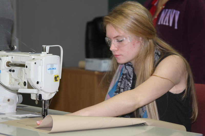Cape High senior Audrey Scroggs concentrates during a sewing test at First State Manufacturing in Milford. BY MELISSA STEELE