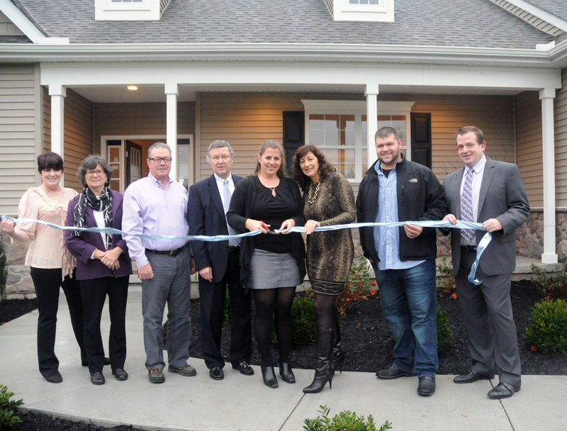 Shown at the ribbon cutting are (l-r) Katie Soyka, stager; Pat Coluzzi, Realtor; Jack O'Hollaren, Realtor; Bruce Plummer, broker; Kathy Newcomb, site sales agent; Beth Dorman, site sales agent; Chris Tackett, Seacoast Communities building superintendent; Joe Dell Torre, mortgage consultant, Fairway Mortgage Consultants. BY STEVEN BILLUPS