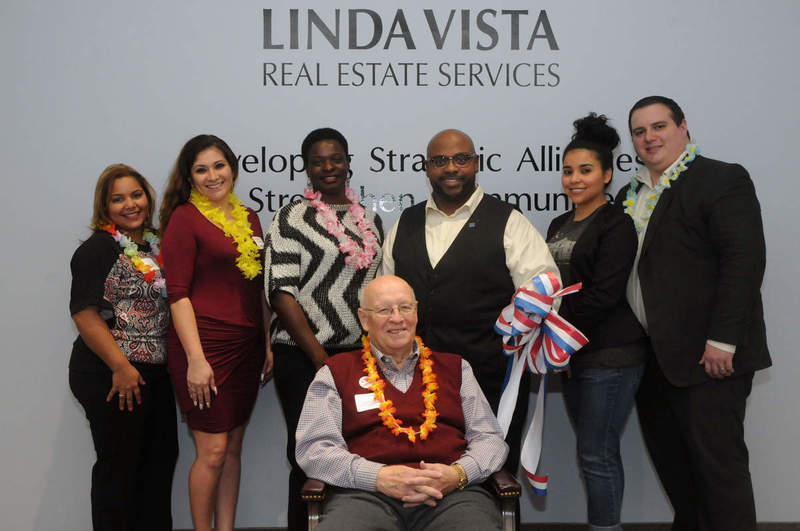 Standing in front of the company motto, "Developing strategic alliances to strengthen communities," Linda Vista Real Estate Services employs a full staff of bilingual agents. Shown (l-r) Lesmayra Bautista, service administrator; Frannie Esparza, Realtor; Yvette Quiñones; José Quiñones, owner and Realtor; Mirla Aleman, building owner; and Craig Aleman, real estate attorney. Seated in front, Lit Dryden, broker. BY STEVEN BILLUPS