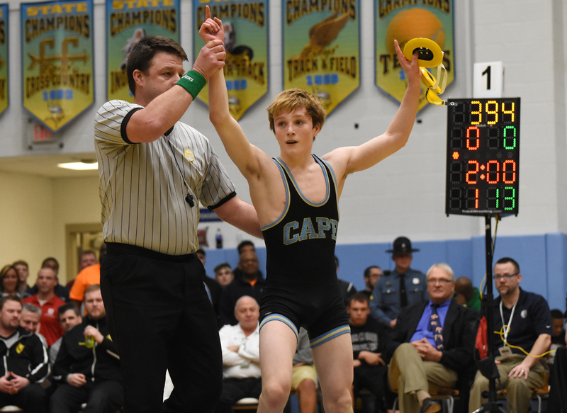 Cape's Anthony Caruso raises his arm in victory following a successful bout in the 106-pound championship match. BY NICK ROTH