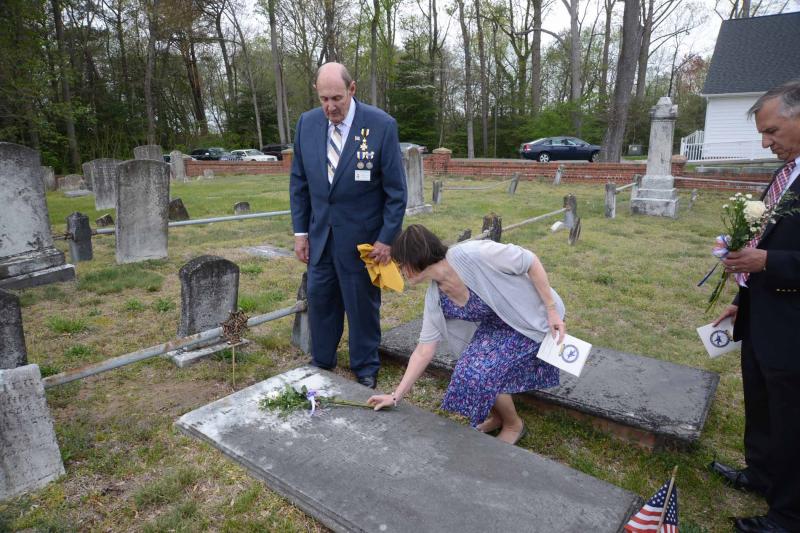 With the marker unveiled by SAR Historian William Richardson, left, on William Peery's grave, Cheryl Vitelli, an elder with Coolspring Presbyterian Church, lays flowers on the grave stone. In 1776 Peery was given the command of a company of soldiers "for the safeguard of the pilots and the persons and goods of other well affected inhabitants residing or being near Lewiston and the coasts of the Delaware Bay." Perry also protected George Washington's camp at Valley Forge. His notable accomplishments as a public servant and statesman include election to the State House for eight sessions; service as a delegate at the Continental Congress; service as the first treasurer of Sussex County; and as an elder of Coolspring Presbyterian Church. BY STEVEN BILLUPS