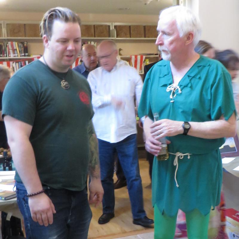 Milton resident Michael Feifer, left, chats with Paul Barnette, costumed as Peter Pan for the UUSD Journey to Neverland-themed annual auction and fundraiser. BY MOLLY MACMILLAN