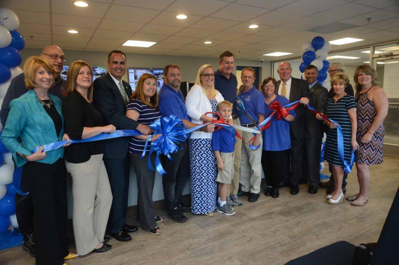 Shown at the ribbon cutting are (l-r) Betsy Reamer, Lewes Chamber executive director; David Hill; Stephanie Krause-Fulton; Sen. Ernie Lopez, R-Lewes; Patty Burketine, RBDBCC membership representative; Mark Kimble, assistant manager; Timarie, Chase and Blair Thompson, owners; Jim McCoy, assistant manager; Cindy McGinnis, manager; Rep. Pete Schwartzkopf, D.-Rehoboth; Rep. Steve Smyk, R-Milton; Steven Prestipino, Apple Electric president; Carol Everhart, RBDBCC executive director; and Lauri Chasten. STEVEN BILLUPS PHOTO Ribbon