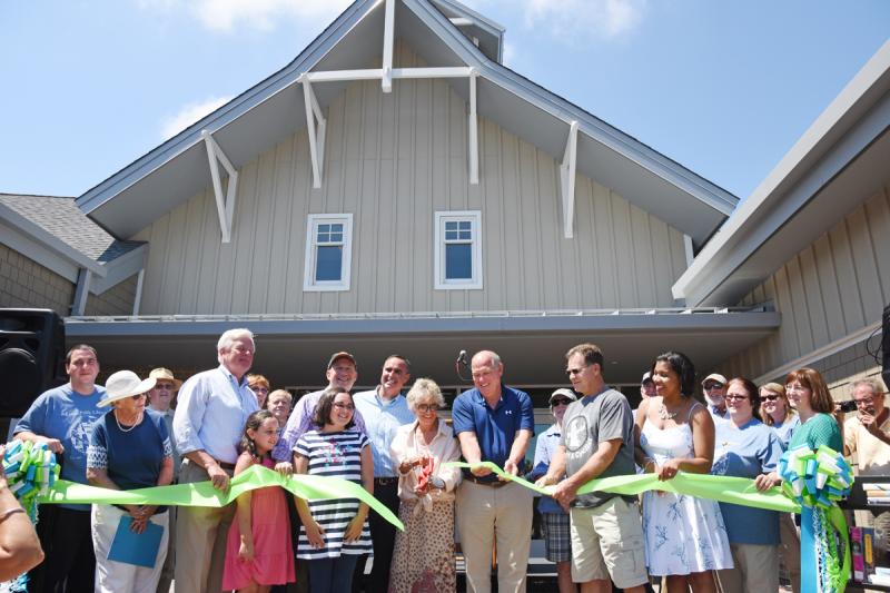 Helping officially cut the ribbon for the new Lewes Public Library are (l-r) library director Ed Goyda; Barbara Vaughan, library board commissioner; Fred Beaufait, city councilman; Mayor Ted Becker; Annie Norman, state librarian; Claire Lopez; Anna Lopez; Gov. Jack Markell; Sen. Ernie Lopez, R-Lewes; library board President Beckie Healey; Rep. Pete Schwartzkopf, D-Rehoboth Beach; Bonnie Osler, city councilwoman; Jim Ford, former Lewes mayor; Hugh Leahy, library board commissioner; Chanta Wilkinson, library board commissioner; Dennis Forney, capital campaign chairman; Margaret Melson, library technical services; Kristen Baker; Maureen Miller, assistant director for youth services; Kristen Gramer, assistant library director; and Doug Miller. NICK ROTH PHOTO