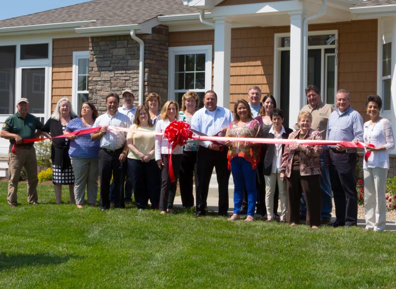 Shown during the ribbon cutting are (l-r) Wayne Mills, Nancy Groom, Michelle Spence, Mario Roca, Justin McConnell, Rhonda Palmer, Carol Wilkins, Elaine Taylor, Robin Bunting, Mike Fannin (president, Country Life Homes), Tina Fannin, Stan Bradley, Brandi Ford, Susan Pomerantz, Bev Manning, Carl Hicks, Kevin Harding and Gwen Greenly. SOURCE SUBMITTED