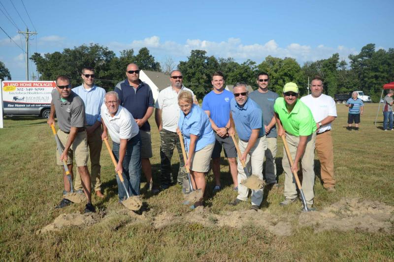 Shown at the groundbreaking in back are (l-r) Dustin Parker, Bay to Beach Builders; Bryan and Mike White, C. White & Sons LLC; Henry Hall, Hall Distributors LLC; Ray Williams and Randy Wheatley, Raymond E. Williams Plumbing. In front are Steve Phillips, 84 Lumber-Milford; Dave Rambo, Sam Yoder & Son LLC ; Carla and Deric Parker, Bay to Beach Builders owners, and Brian Swain, Fancy Cutz LLC.