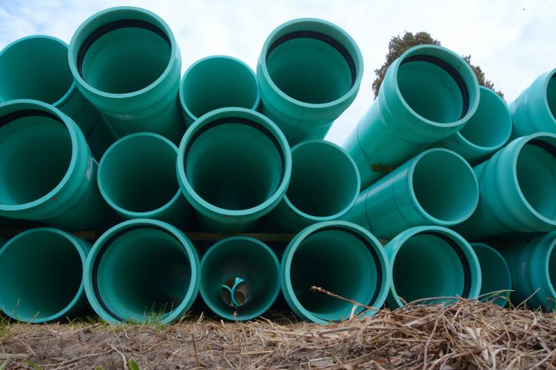 Pipes were staged along Route 5 this summer in preparation for a line extension from Lewes to Sussex County's Inland Bays wastewater treatment plant near Long Neck. That connection, as well as upgrades to the Inland Bays facility and new partnerships between the county, City of Lewes and Artesian, will make a proposed land conversion off Wolfe Neck Road possible. RON MACARTHUR PHOTO