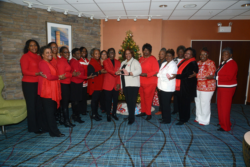 The members of Delta Sigma Theta Sororrity gathered in front of the Christmas tree for a group shot. Shown standing in back are (l-r) Angela Showell, Sabrina Neal, Karen Maull, Doris Person, Wanda Hyland Isler and Hazel Showell. In front, Regina Jones- Brake, Sherita Belle, Veronica Oney, Mary Matthews, Vice President Dana Paskins, President Connie Andrews, Bernice Edwards, Otelia Oliver, Tanya Ricketts Smack, Hattie Bull and Waynne Paskins. Delta Sigma Theta