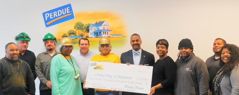 Perdue Farms associates present a check for $33,690.51 to the United Way of Delaware. Shown are (l-r) Anthony Crain; David Doucette; Casey Minnick; Sandra Normil; Dean Walston, director of operations; Linda Smith; John Moore, United Way of Delaware vice president for resource development and strategic partnerships; Christella St. Juste, United Way of Delaware community relations associate; Latasha Cummings; Derrick Mangum, human resources complex manager; and Aleeshia Webster, Perdue United Way campaign coordinator. SUBMITTED PHOTO