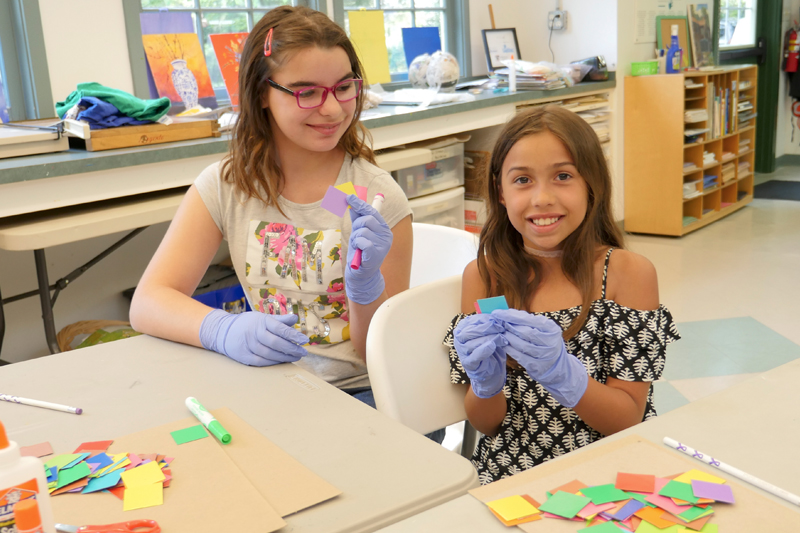 Moira Greer, left, smiles at Amanda Rodrigues during a Studio E session in Rehoboth Beach. The girls were excited to work together on an art project. SUBMITTED PHOTOS