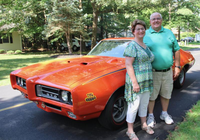 Nancy and Bob Dunbar with their original owner 1969 Pontiac GTO Judge in their Beachfield neighborhood. When Pontiac brought out its first GTO in 1964, it was a special edition of the Tempest, and the initials stood for Grand Tempest Option. Project Manager John DeLorean - of DeLorean auto fame - dictated that the Judge would always be this color orange, which was first patented by Chevrolet and called Hugger Orange. Dunbar said General Motors wouldn’t allow cars in one division - such as Pontiac - to use colors from another division such as Chevrolet. So DeLorean changed the name of the color to Carousel Red for Pontiac and used it for his Judge.