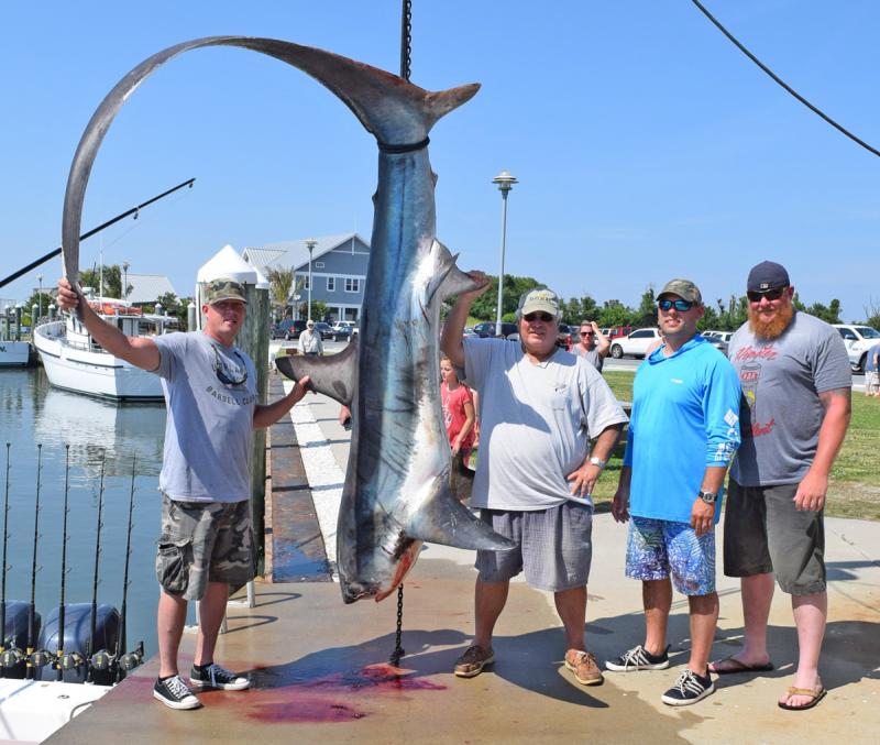 While fishing at the 20-Fathom Fingers using a mackerel fillet and Hook 'em & Cook 'em's custom-made Triple Threat shark chum, angler Shane Martin from Townsend caught this massive 408.2-pound thresher shark. Jeff Waxman of Bethany Beach and Steve Redden from Middletown helped Shane land this shark on the Valkyrie. Shown are (l-r) Martin, Waxman, Brent Rohm and Redden. ,HOOK ’EM AND COOK ’EM PHOTO