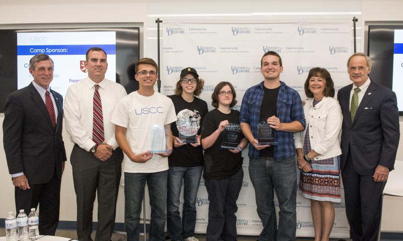 A team of Delaware Tech students won a Capture-the-Flag competition at the U.S. Cyber Challenge Delaware camp, recognizing them as some of the nation's top security talent. Shown are (l-r) Gov. John Carney; Jerrod Bates, Delaware Tech information security instructor; Delaware Tech students Krystian Bates, Hannah Tattan, Hannah Curran and Alex Reuben; U.S. Cyber Challenge National Director Karen S. Evans; and U.S. Sen. Tom Carper. SUBMITTED PHOTO
