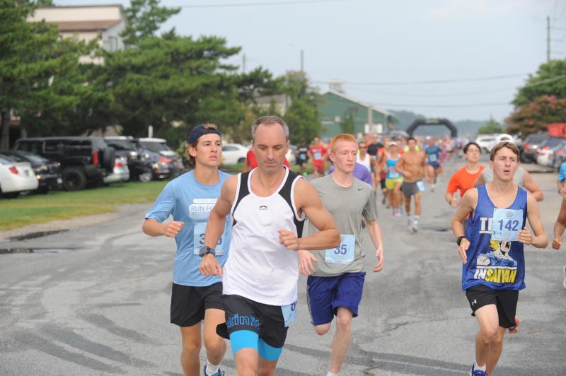 Runners spring up to the corner and around the bend at the Buddy Run 5K in Dewey Beach. DAVE FREDERICK PHOTOS