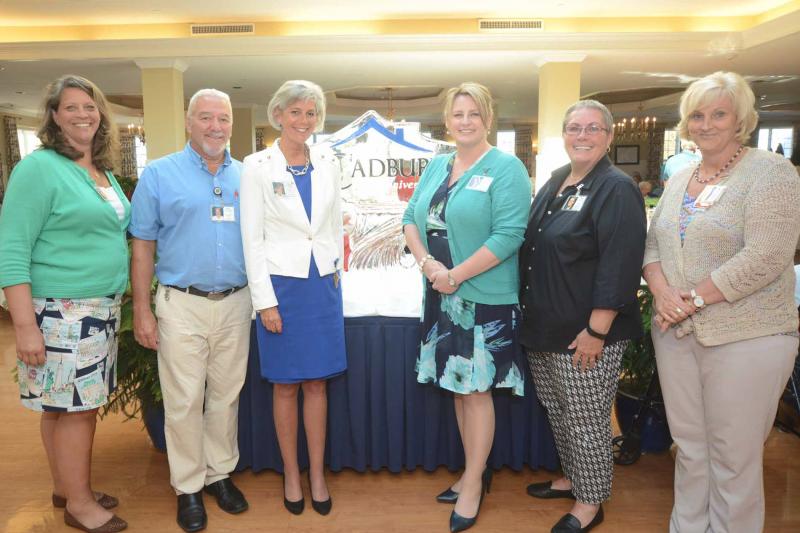 The staff of Cadbury Senior Lifestyles, Lewes gathered in front of an ice sculpture for a group photo, Shown are (l-r) Lauri Weeks, director of residence services; Jeff Smith, director of dining; Carol Holzman, executive director; Karen Kerstetter, director of sales; Deb Hamilton, retiring director of residence services; and Ruthanne Jacobs, director of nursing.