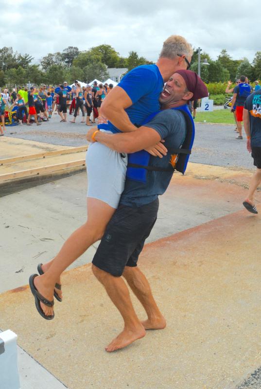Dan Matta gives Chris Schell a hug and lift after Schell Brothers wins the Lewes Dragon Boat Festival.