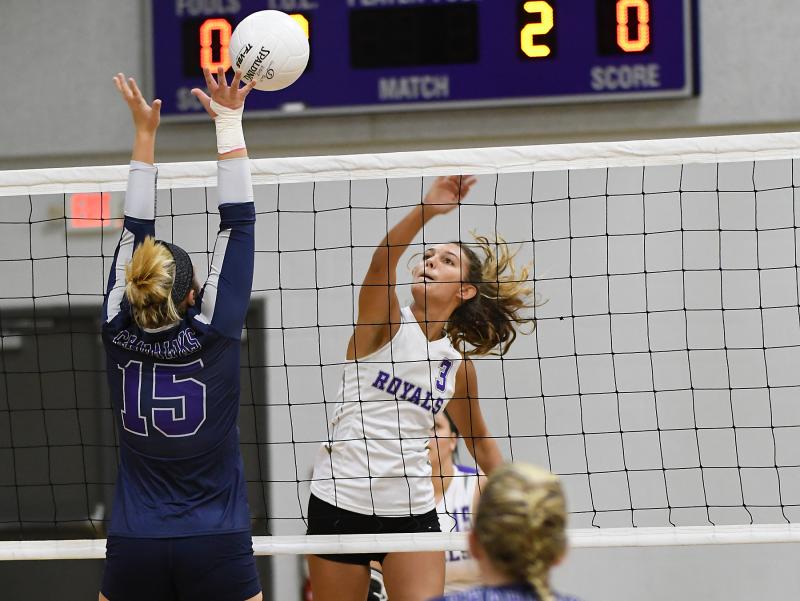 Delmarva Christian senior Charlize White powers a spike into the block of SAS senior captain Bailey Hesson. DAN COOK PHOTOS