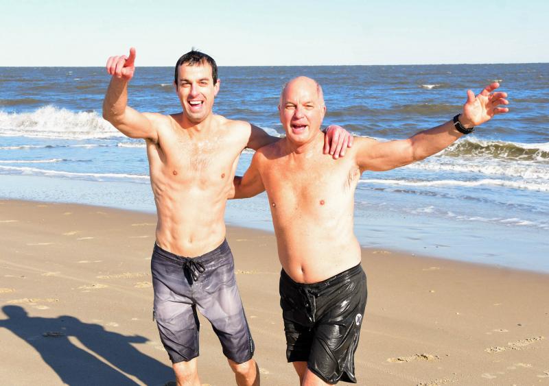 The father-and-son duo of polar bear plungers Greg, right, and Bryan Mack leave the icy Atlantic after taking the annual New Year’s Day plunge. DAN COOK PHOTOS
