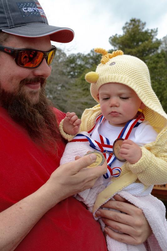 Michael Coleman of Belair, Md., holds 11-month-old daughter Novalee, a fifth-generation kite flyer and winner of two medals.