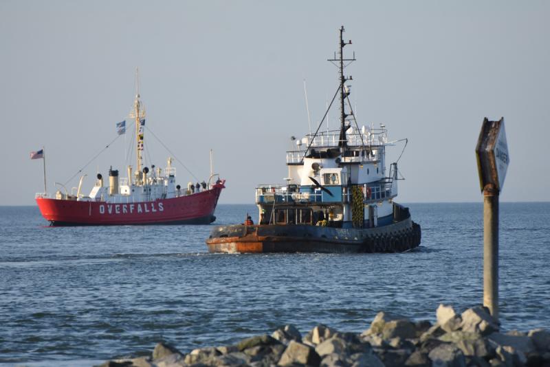 A tug boat heads out of Roosevelt Inlet as the Lightship Overfalls waits for high tide to come in. NICK ROTH PHOTO