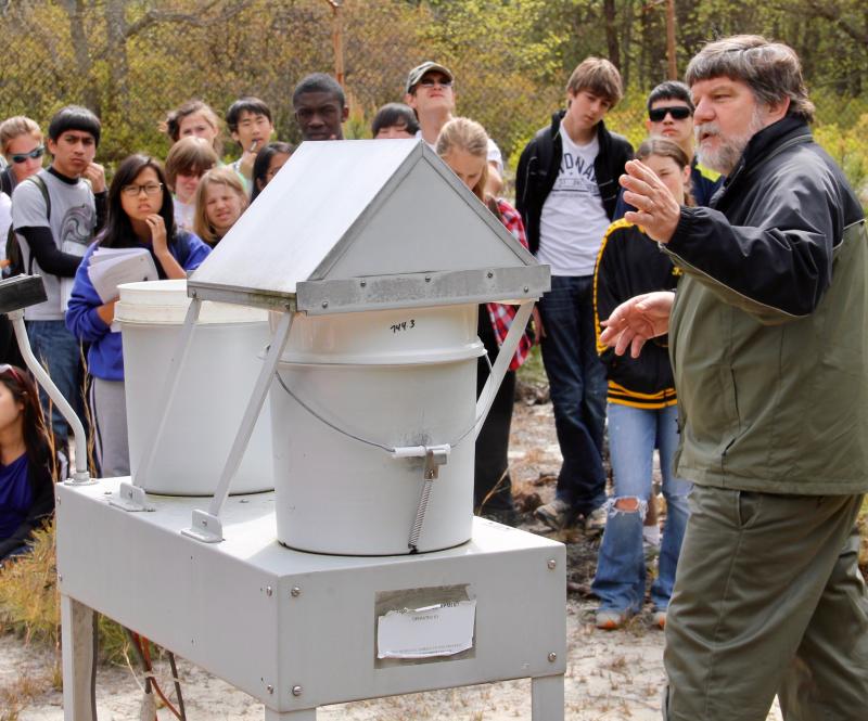 Joe Scudlark demonstrates a solar-powered rainwater collection device for a group of students in spring 2012. The device is part of an array of equipment that was collecting environmental data in Cape Henlopen State Park since 1977. The site has been cleared since last September when funding for the monitoring program was lost. DENNIS FORNEY PHOTO