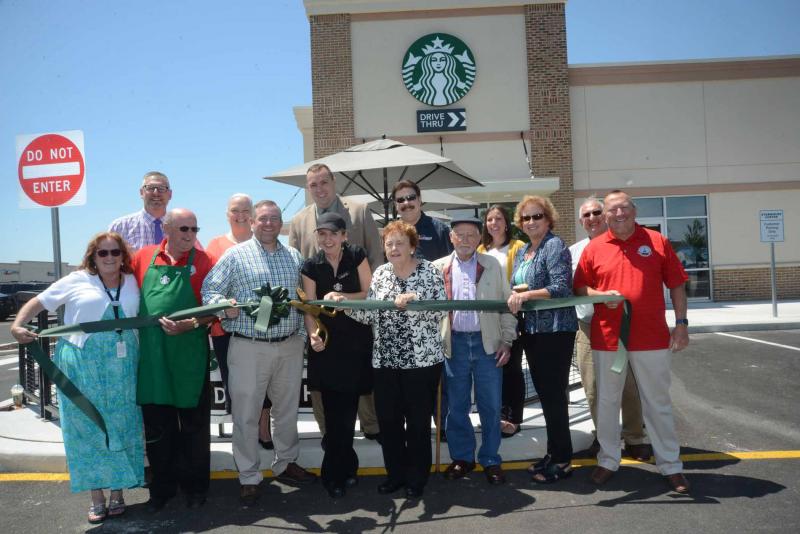 Shown at the ribbon-cutting in back are (l-r) Gene Dvornick, Georgetown town manager; Donna Koskey, chamber president; Sen. Brian Pettyjohn, R-Georgetown; Anthony DelFranco, chamber treasurer; Jamie Craddick; and Randy Cash. In front are Linda Price, chamber first vice president; Mayor Bill West; David Pinand, Starbucks district manager; Laura Dye, store manager; Helen Kruger, chamber board member; Fred Slabaugh, former owner of Georgetown House; Jocelyn Godwin, Georgetown planning and zoning; and Steve Hartstein, town council. Starbucks Georgetown