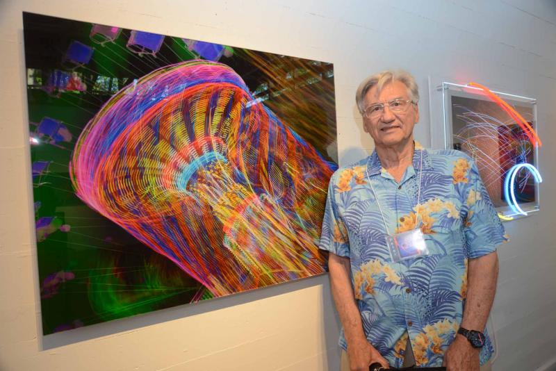 Peter Treiber stands next to one of his abstract expressionist photographs. RAL Opening reception