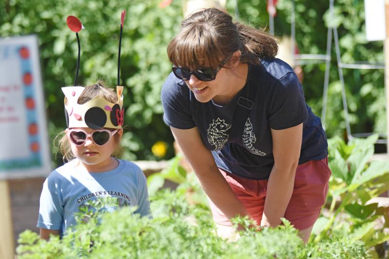 Maeva Colona, 5, of Lewes, left, and her mom Beth check out the Children’s Learning Garden in Stango Park. Maeva and dozens of other children later released 3,000 ladybugs into the garden. NICK ROTH PHOTOS