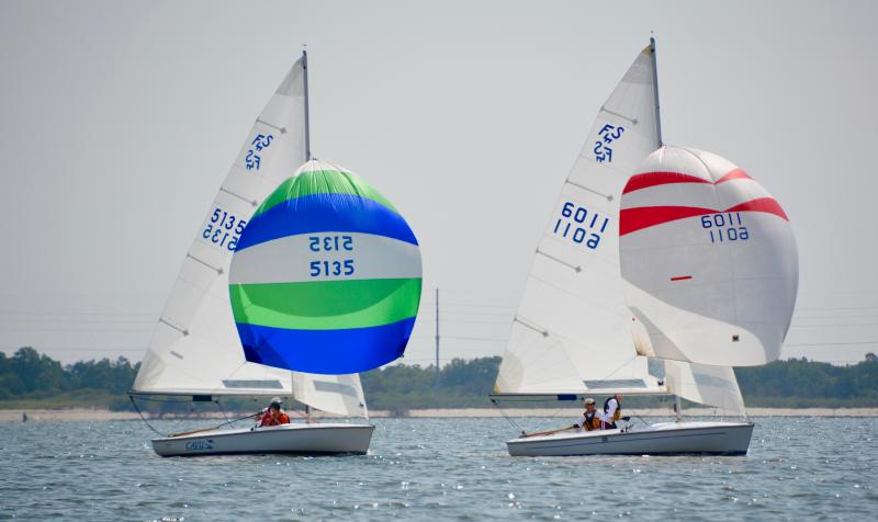 Capturing the wind with their spinnakers are the second- and third-place finishers in the regatta. Finishing second is the crew of 6011, Mark Benner, skipper, and Maria Benner, and finishing third is the 5135 crew of Chris Swenson, skipper, and Alex Diaz.
